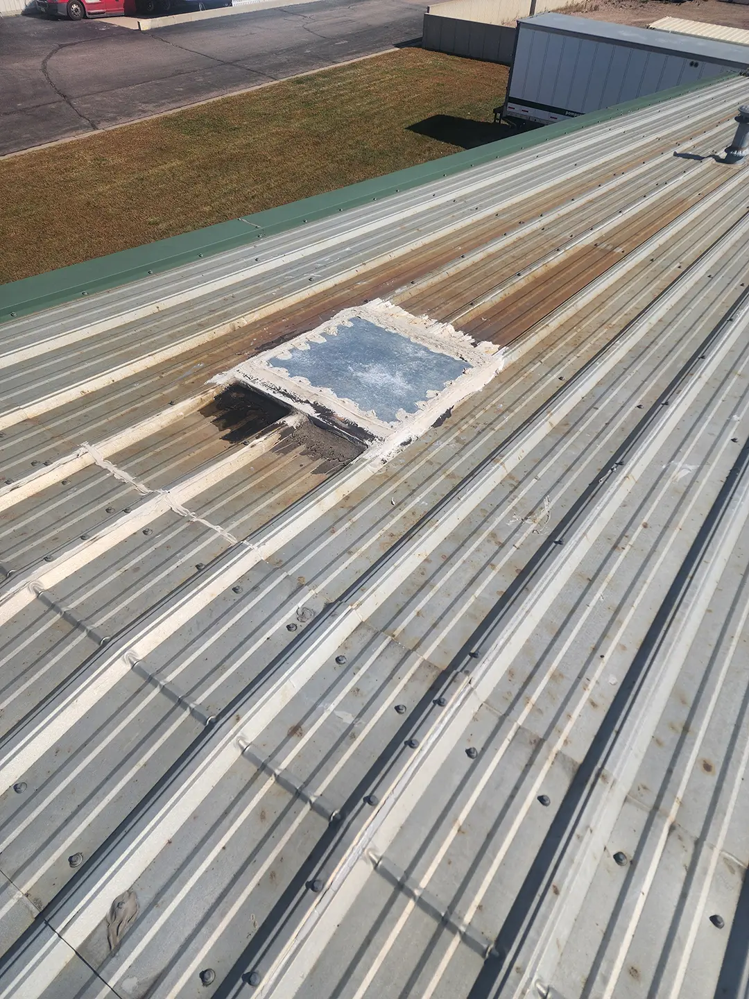 Damaged metal roof panel before repair Sioux Falls, SD